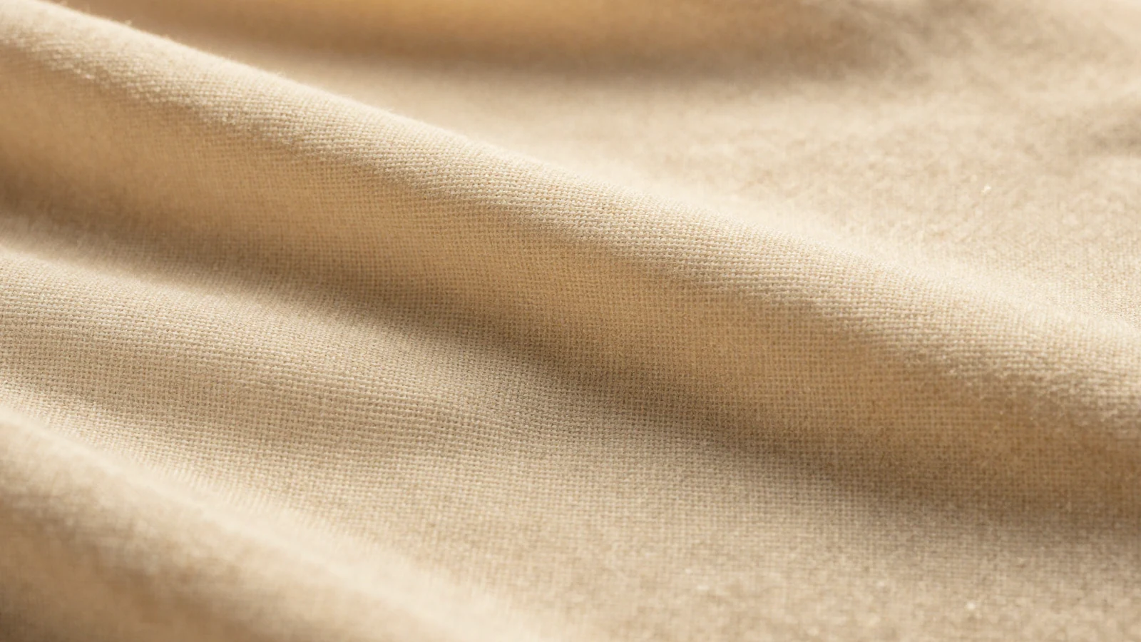 Macro de textura natural luminosa junto a lino suave, metáfora de textura y luminosidad facial.